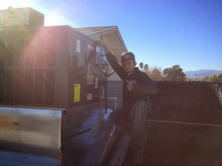 HVAC technician performing AC Tune-Up on a rooftop unit in New Cumberland